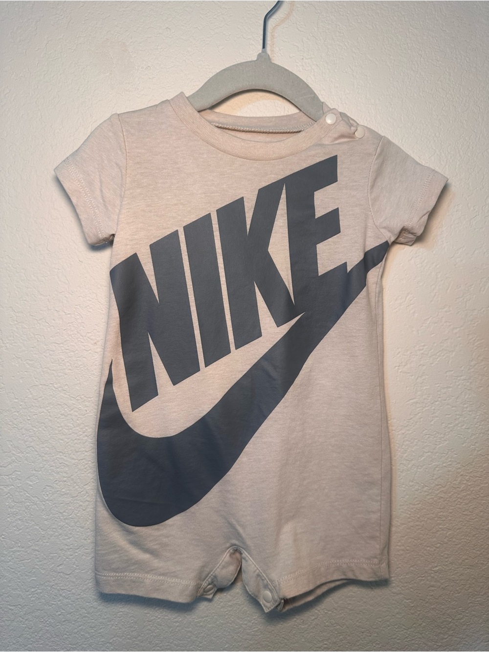 Nike Kids One-Piece Bodysuit in Light Cream with Gray Logo